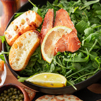Wild smoked sockeye salmon salad with arugula, lemon and crackers