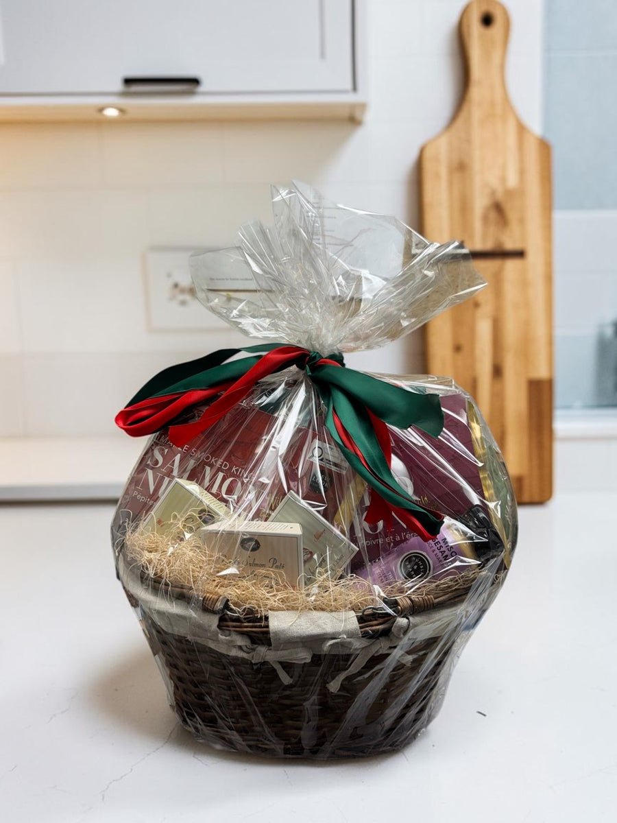 Wild Seafood Gift Basket — wrapped wicker basket of West Coast Select products on a bright kitchen counter