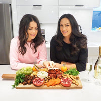 two women with freshly cooked dishes