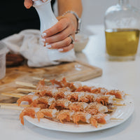 woman preparing Spot Prawns dish